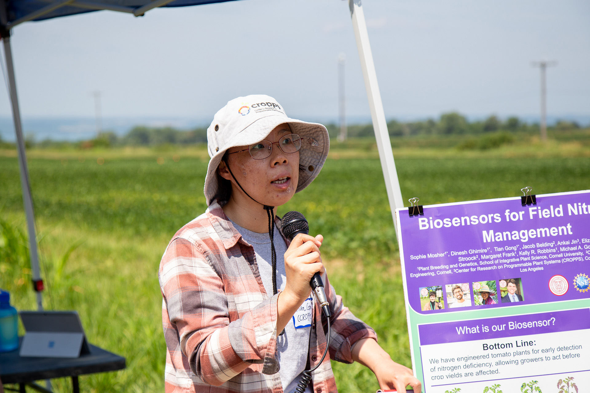 a woman speaks to the crowd at the musgrove demonstration fields
